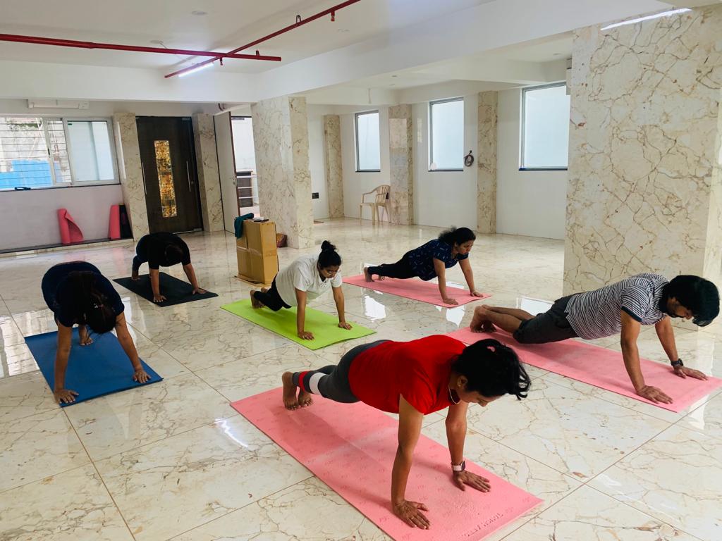 Yoga instructor guiding students in Pune
